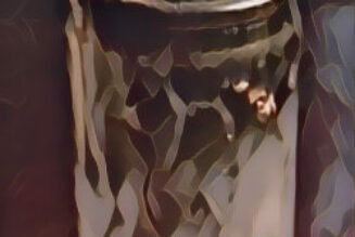 A glass-encased candle